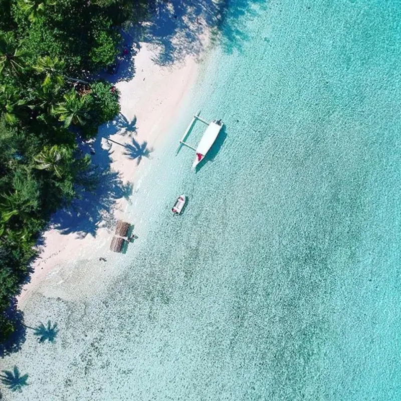 a man flying through the air while riding a wave in the ocean