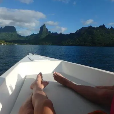 a group of people sitting in front of a body of water