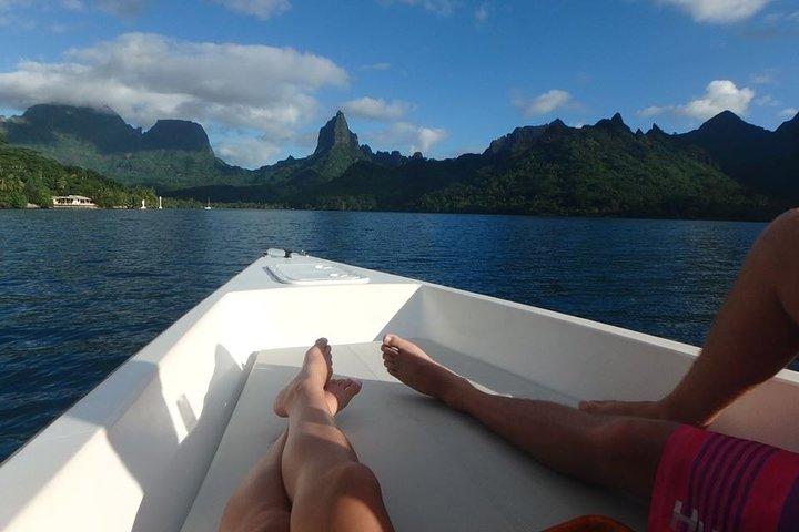 a group of people sitting in front of a body of water